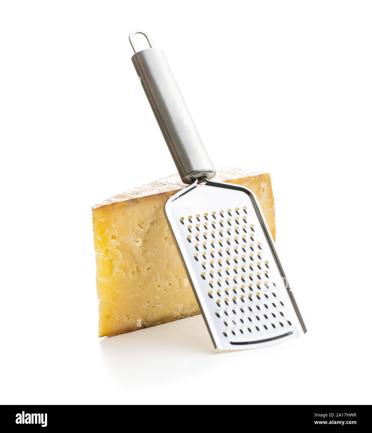 Tasty cheese block and cheese grater isolated on white background Stock ...