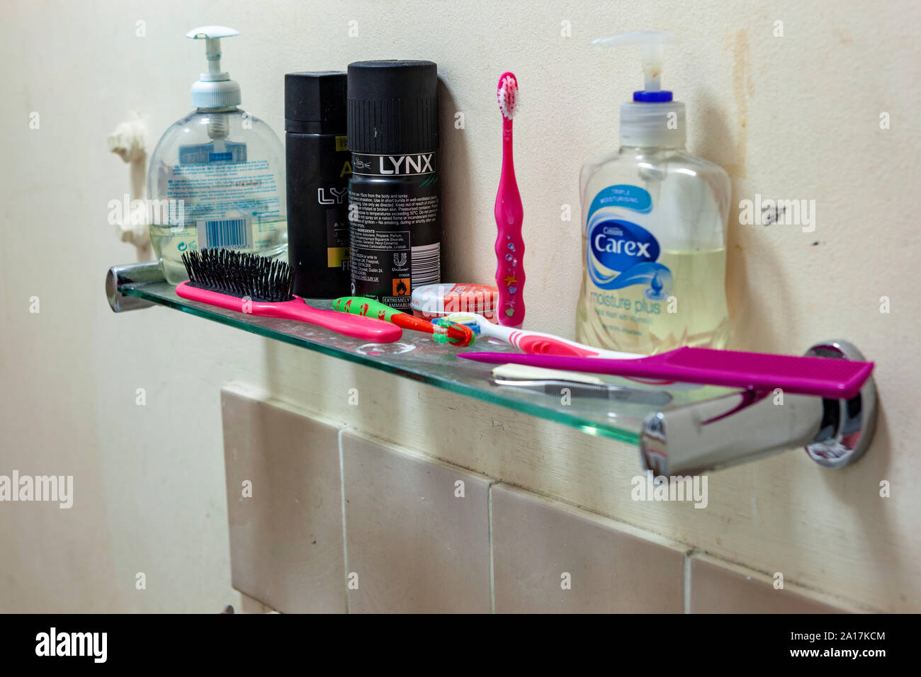 WELWYN GARDEN CITY, UK - SEPTEMBER 23, 2019: Messy bathroom shelf with tooth brushes and soap Stock Photo
