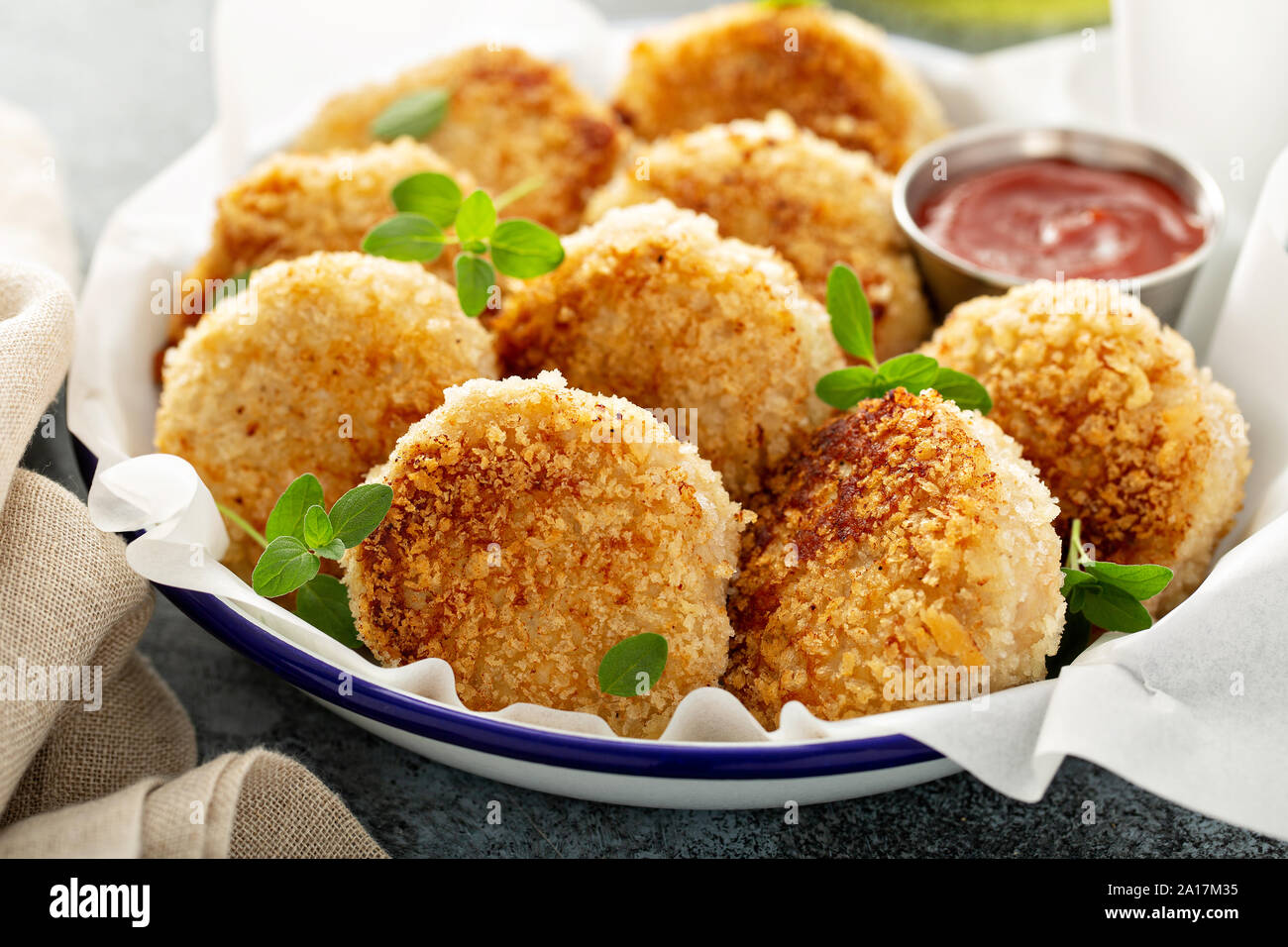 Chicken patties or fish cakes fried in breadcrumbs with ketchup Stock Photo