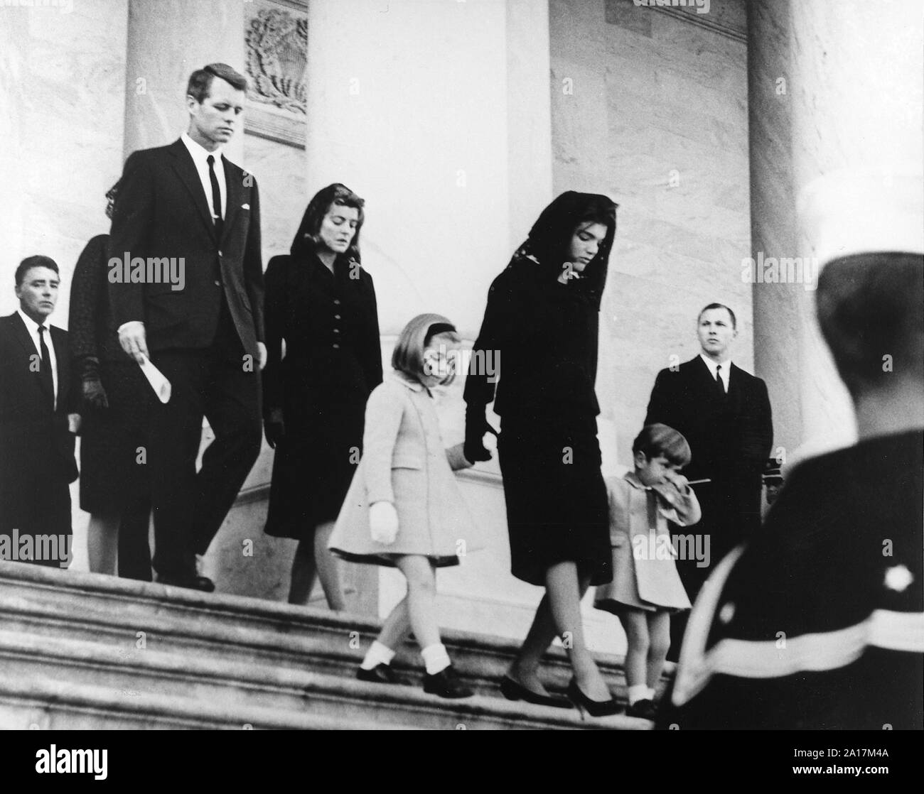 President Kennedy's family leaving his funeral at the U.S. Capitol Building. President's Family leaves Capitol after Ceremony. Caroline Kennedy, Jacqueline Bouvier Kennedy, John F. Kennedy, Jr. (2nd row) Attorney General Robert F. Kennedy, Patricia Kennedy Lawford (hidden) Jean Kennedy Smith (3rd Row) Peter Lawford. United States Capitol, East Front, Washington, D.C. Stock Photo
