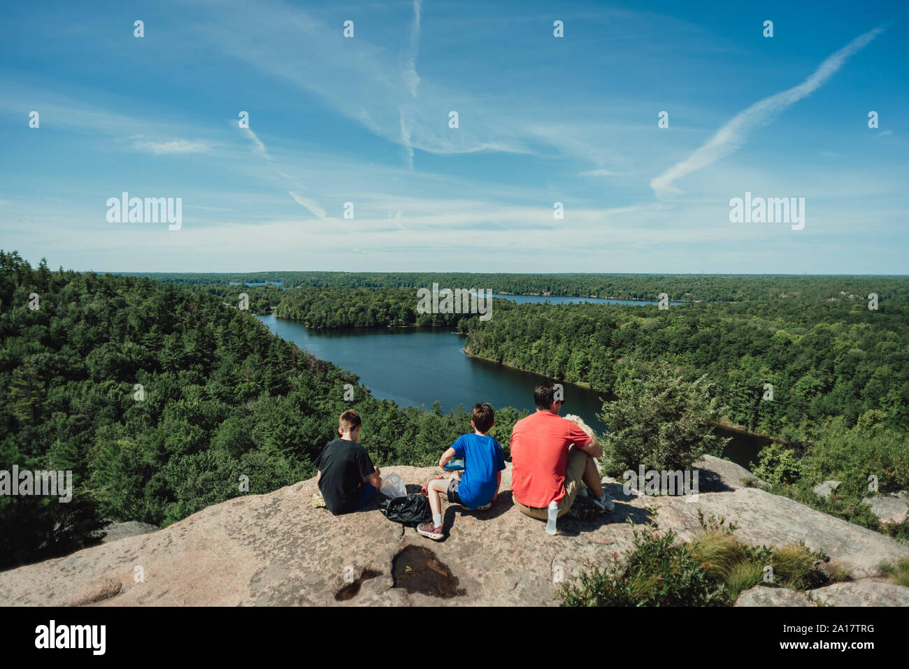Boys sitting on rock river hi-res stock photography and images - Alamy