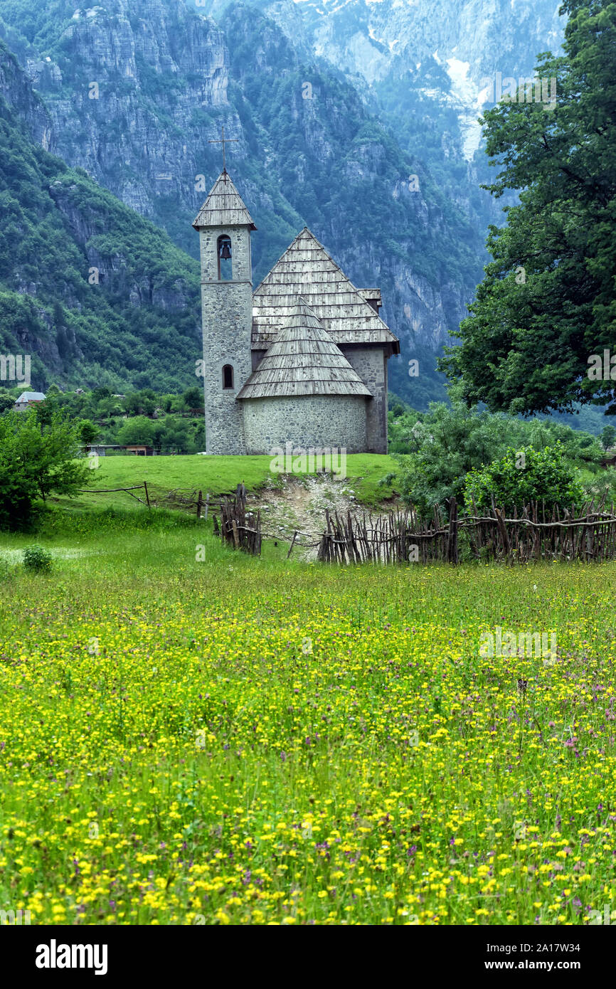 Flowers and small Church in Theth Valley, Albania Stock Photo