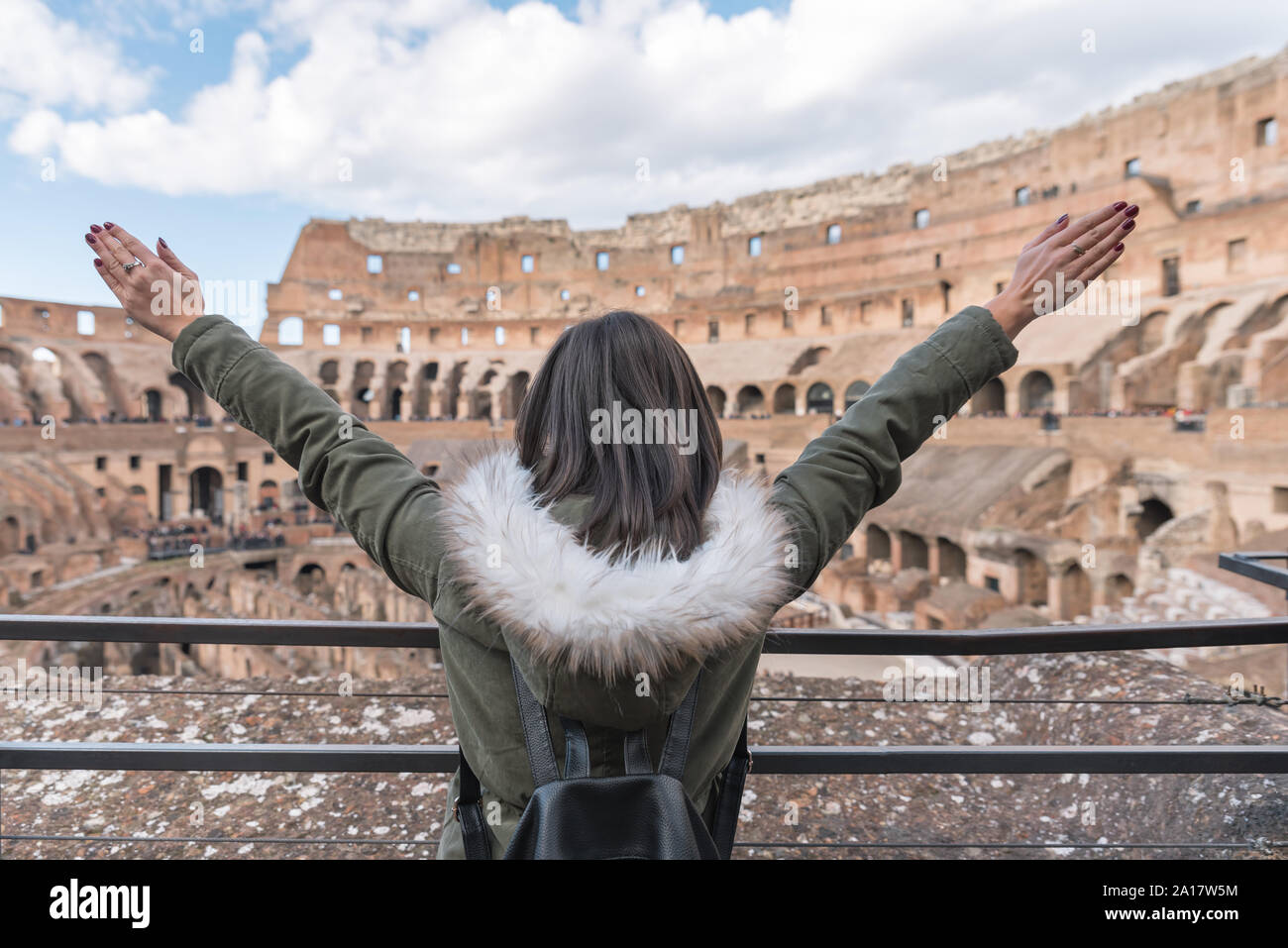 Woman rising her arms in sign of happiness inside the Colosseum Stock ...