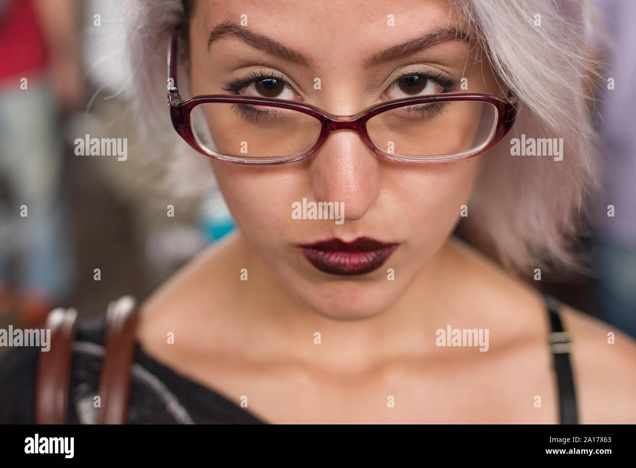 Young woman with white hair, dark red lips and glasses Stock Photo