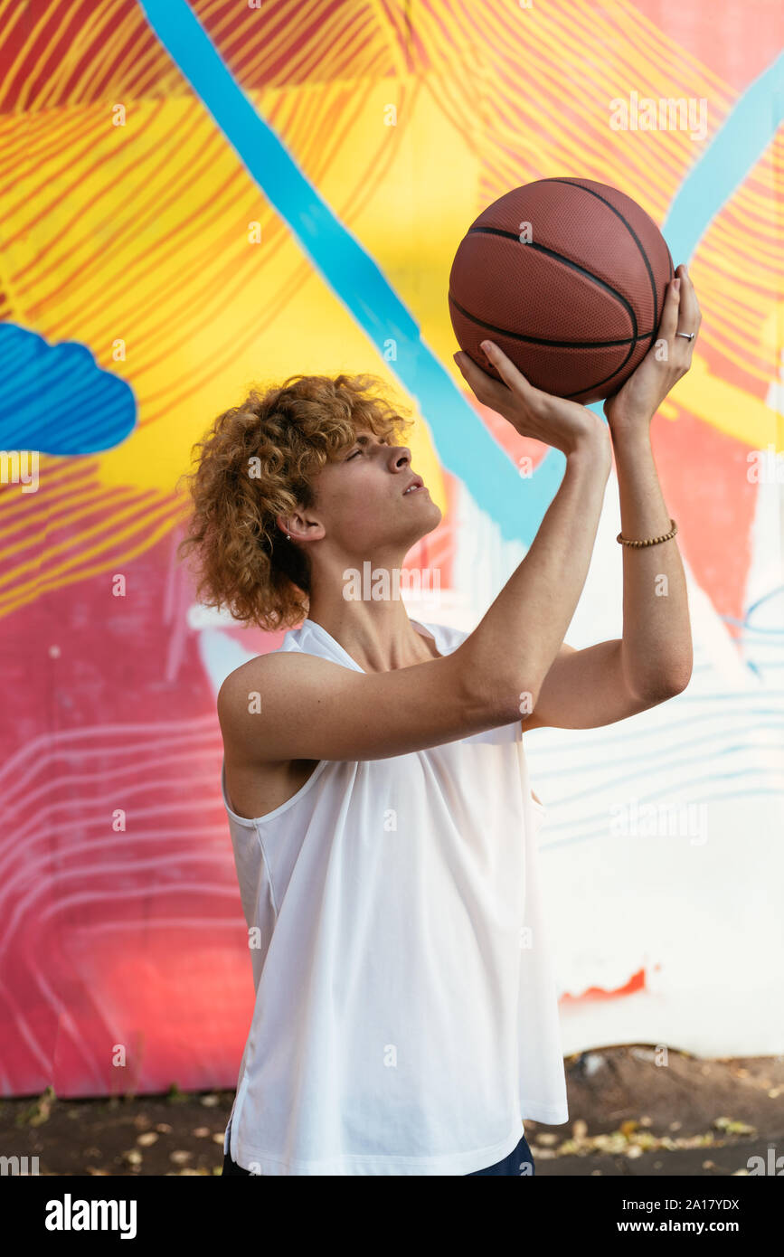 Young Basketball street player preparing for taking a jump shot Stock Photo
