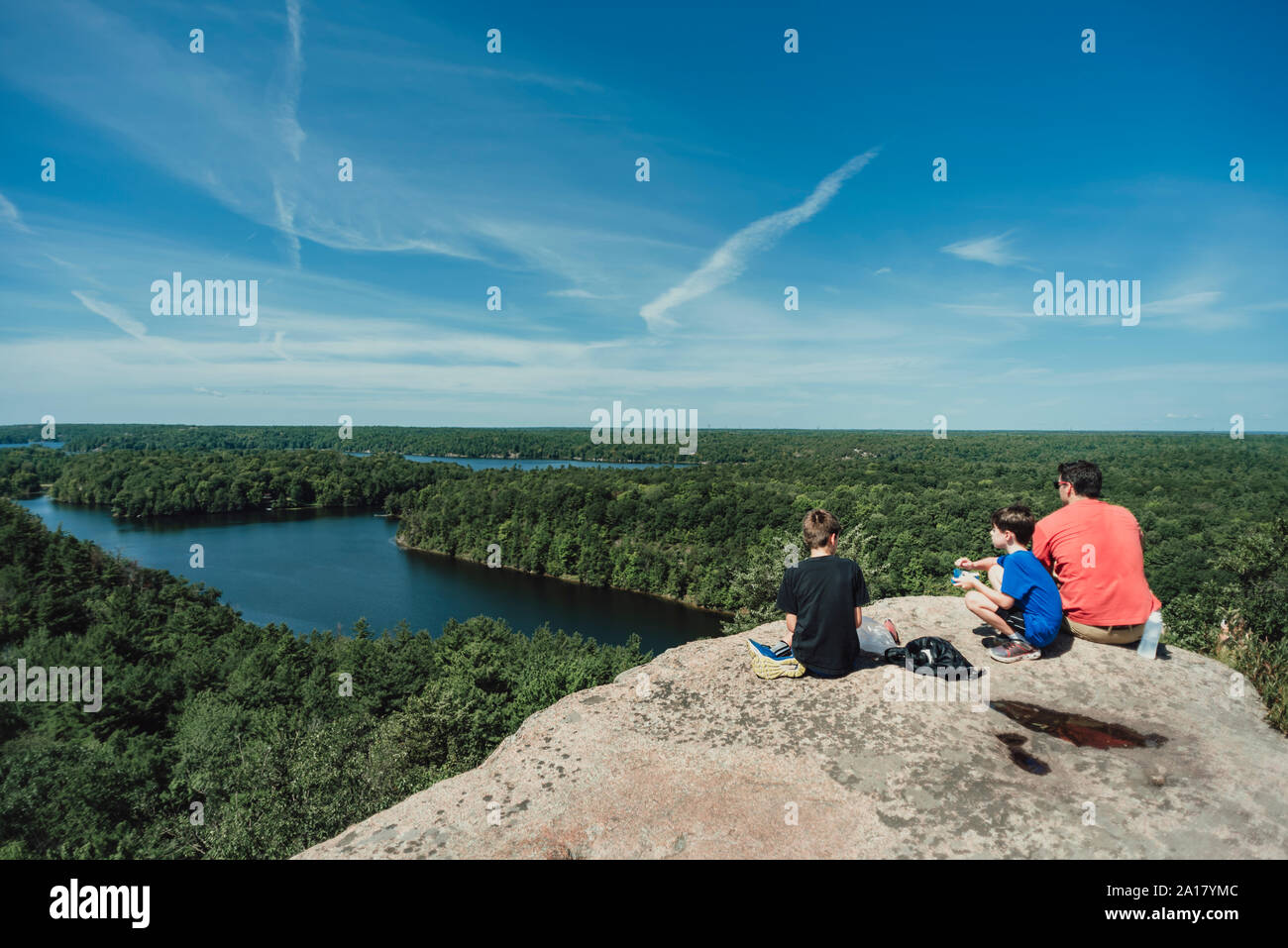 Boys sitting on rock river hi-res stock photography and images - Alamy