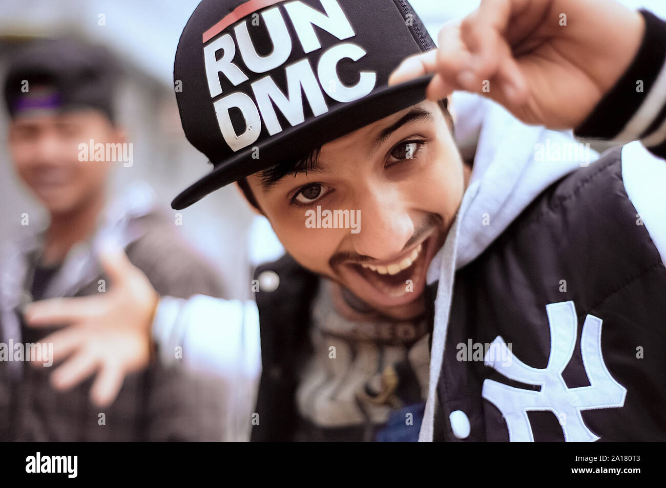Young  playful guy wearing hip hop cap and sports clothing Stock Photo