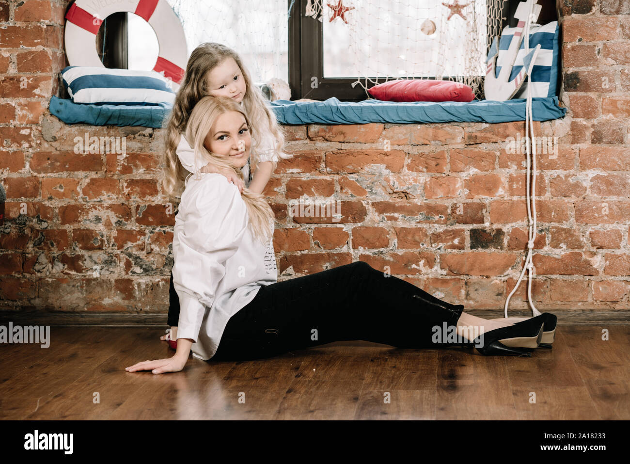 Little Girl And Her Mother Woman Relaxing And Enjoying By Sitting