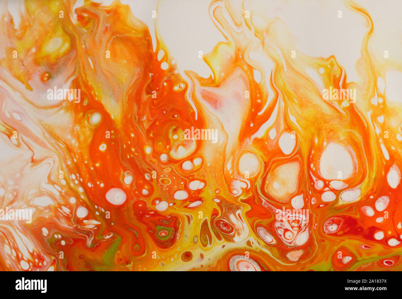 A blaze of fall color warms this abstract acrylic painting in red, orange, and yellow on white that resembles a bonfire for backgrounds. Stock Photo
