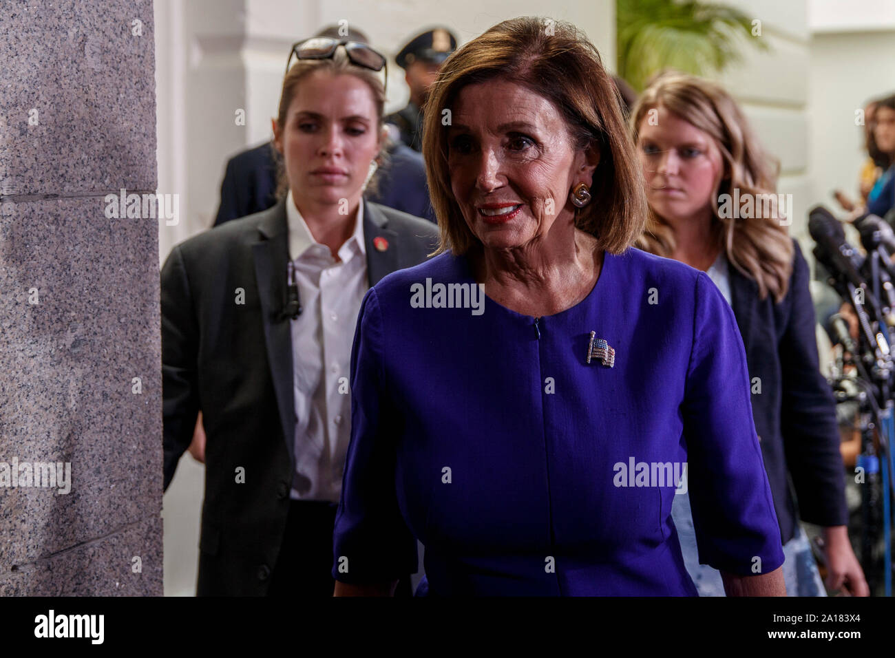 Washington, USA. 24th Sep, 2019. U.S. House Speaker Nancy Pelosi (front) walks to her office on Capitol Hill in Washington, DC, the United States, on Sept. 24, 2019. Nancy Pelosi announced Tuesday the initiation of a formal impeachment inquiry against President Donald Trump over the latter's controversial phone call with the Ukrainian president. Credit: Ting Shen/Xinhua Stock Photo