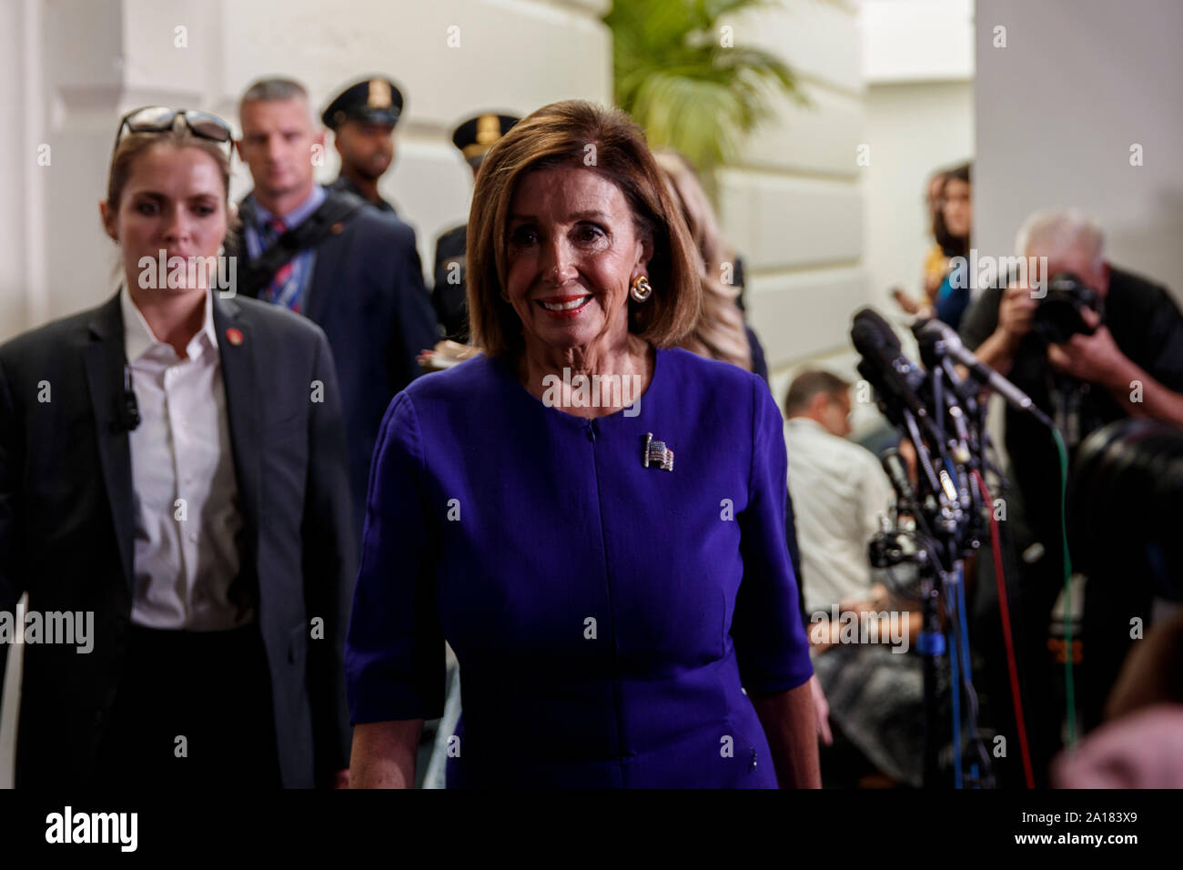 Washington, USA. 24th Sep, 2019. U.S. House Speaker Nancy Pelosi (front) walks to her office on Capitol Hill in Washington, DC, the United States, on Sept. 24, 2019. Nancy Pelosi announced Tuesday the initiation of a formal impeachment inquiry against President Donald Trump over the latter's controversial phone call with the Ukrainian president. Credit: Ting Shen/Xinhua Stock Photo