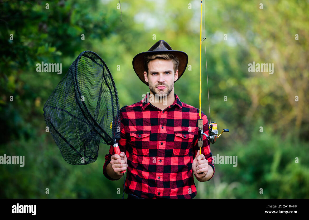 https://c8.alamy.com/comp/2A184HP/casting-off-serious-man-in-cowboy-hat-western-portrait-vintage-style-man-wild-west-retro-cowboy-fly-fishing-man-checkered-shirt-on-ranch-fisher-hold-fish-net-hobby-fisherman-with-fishing-rod-2A184HP.jpg