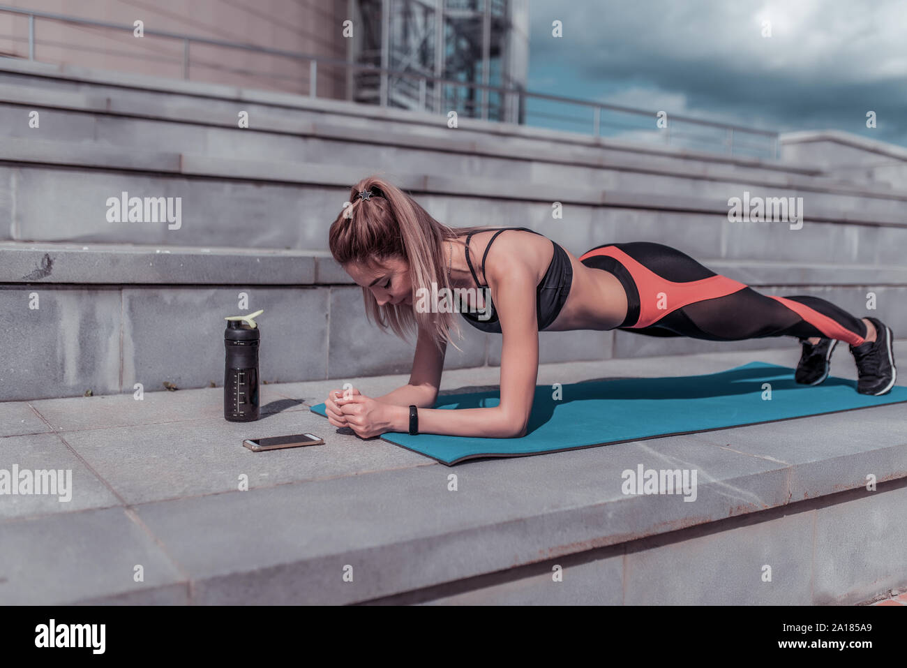 Girl Training Summer In City Stands Emphasis Lying Down Plank Abs Training Abdominal Muscles Woman Back Stretching Flexibility Smartphone Stock Photo Alamy