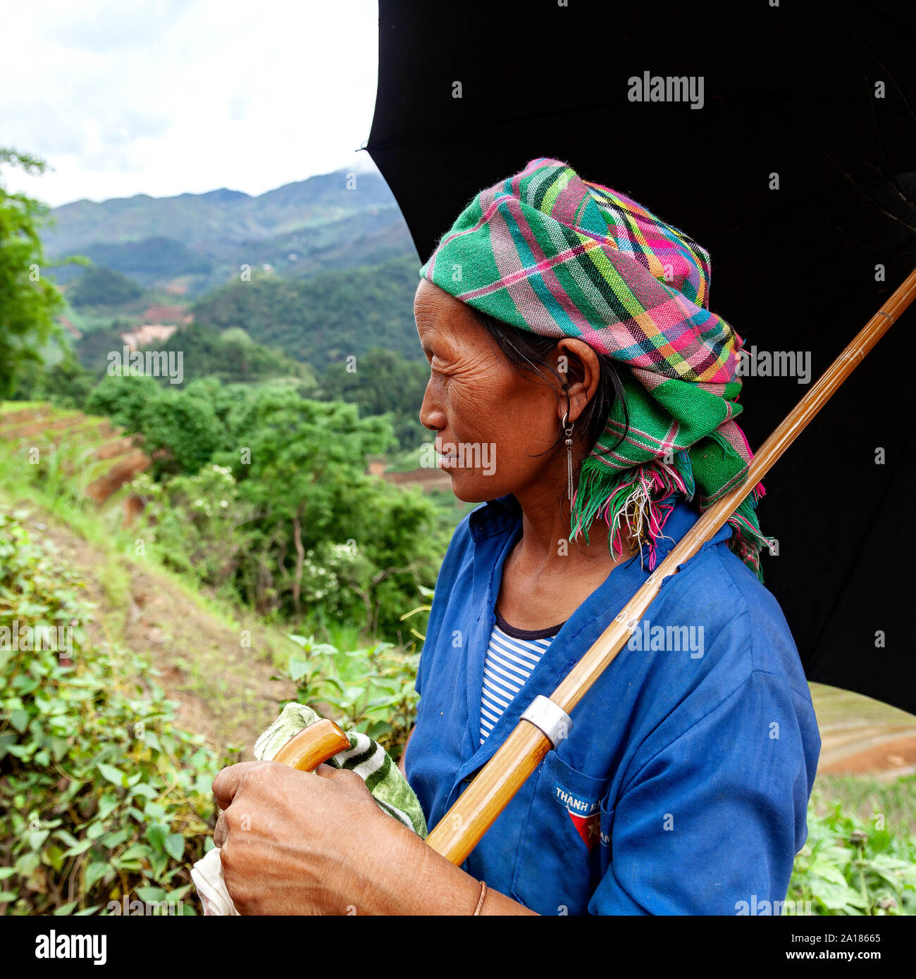 Black Hmong woman on a mountain path, in the Mu Cang Chai area, Yen Bai province, in northwestern part of Vietnam. Stock Photo