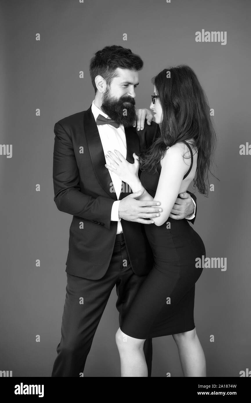 Elegance is not about being noticed. Bearded man wear suit girl elegant  dress. Formal dress code. Visiting event or ceremony. Couple ready for  award ceremony. Corporate party. Award ceremony concept Stock Photo -