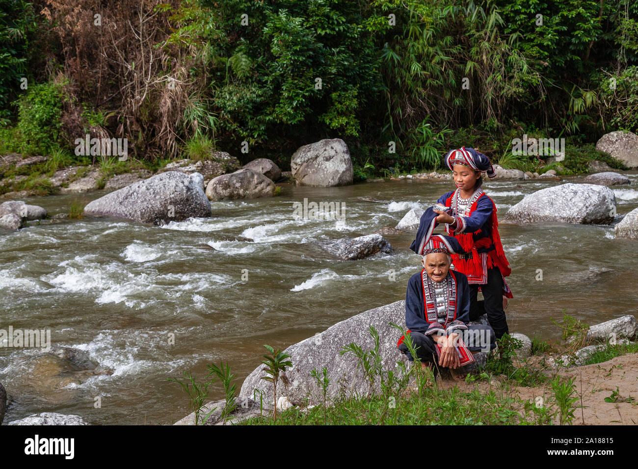 Red Dao ethnic minority women (Dao Do), by a river in Hoang Su Phi, Ha Giang province, in the mountainous northwestern part of Vietnam. Stock Photo