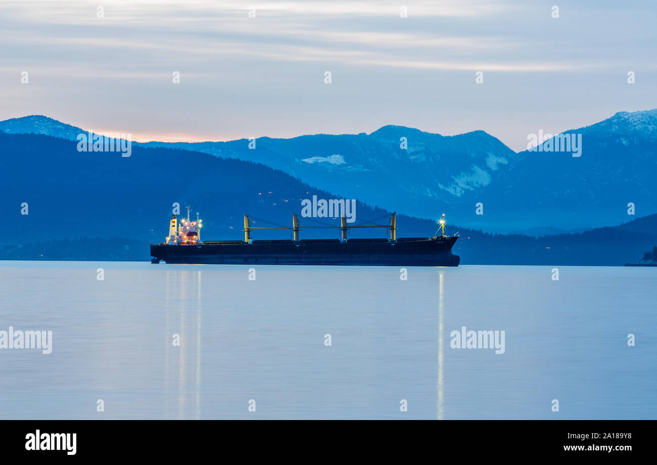 Cargo container ship Velebit moored at the outer harbor of Burrard Inlet in the Port of Vancouver with Coastal Mountains backdrop Stock Photo
