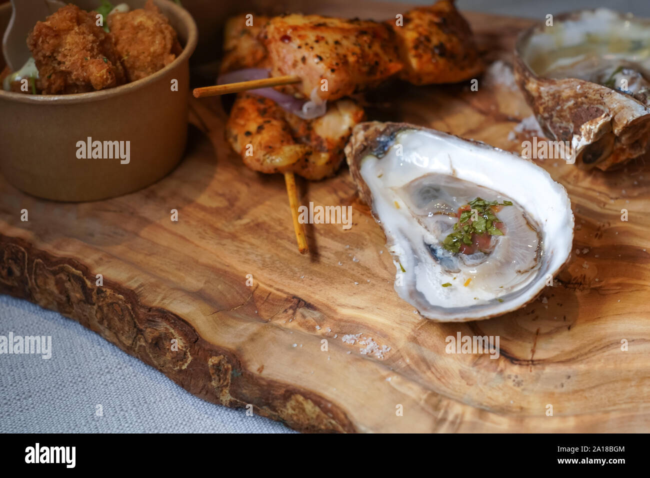close up of raw oyster on a wooden food platter Stock Photo