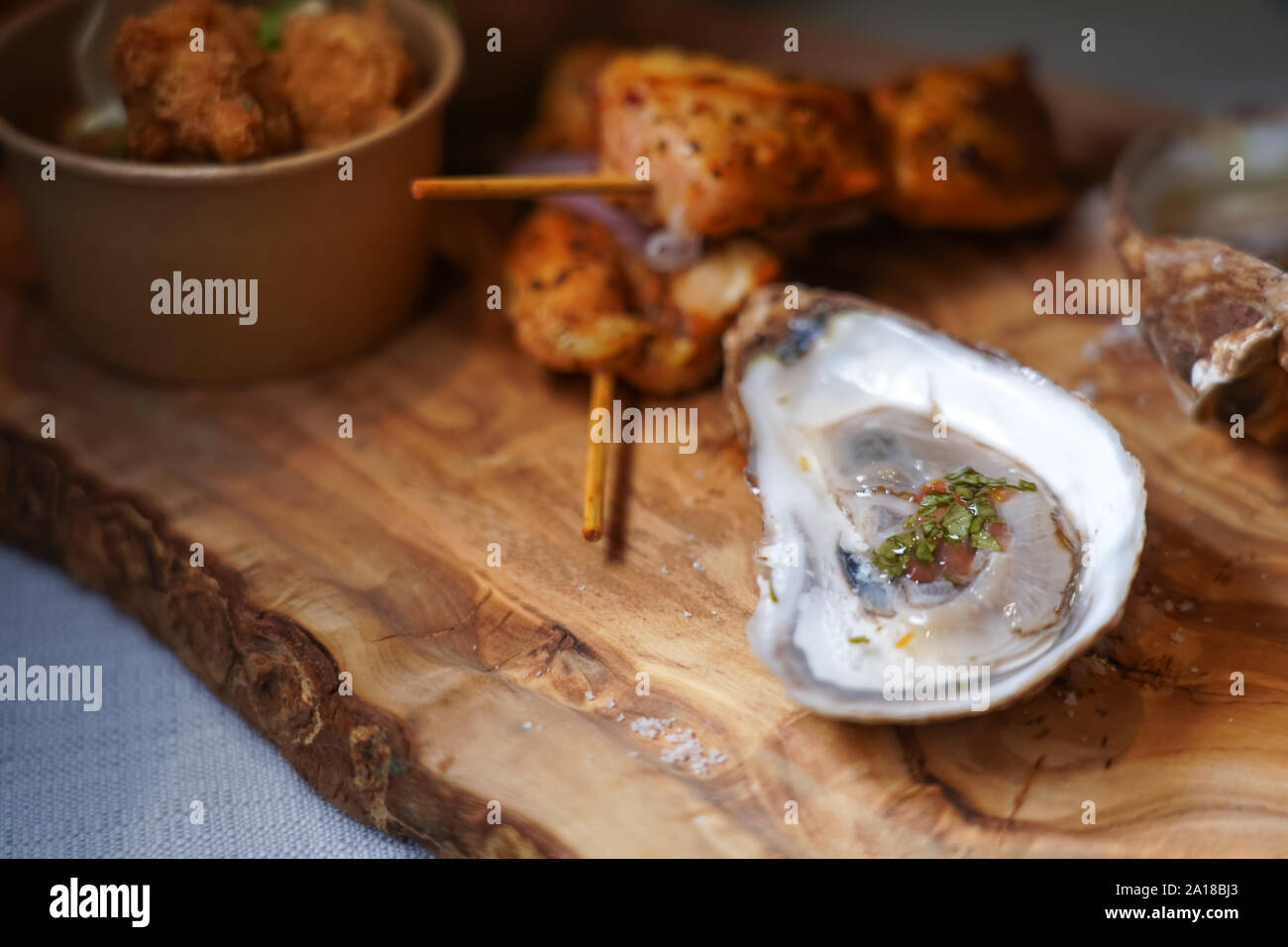 raw oyster on a wooden serving board Stock Photo