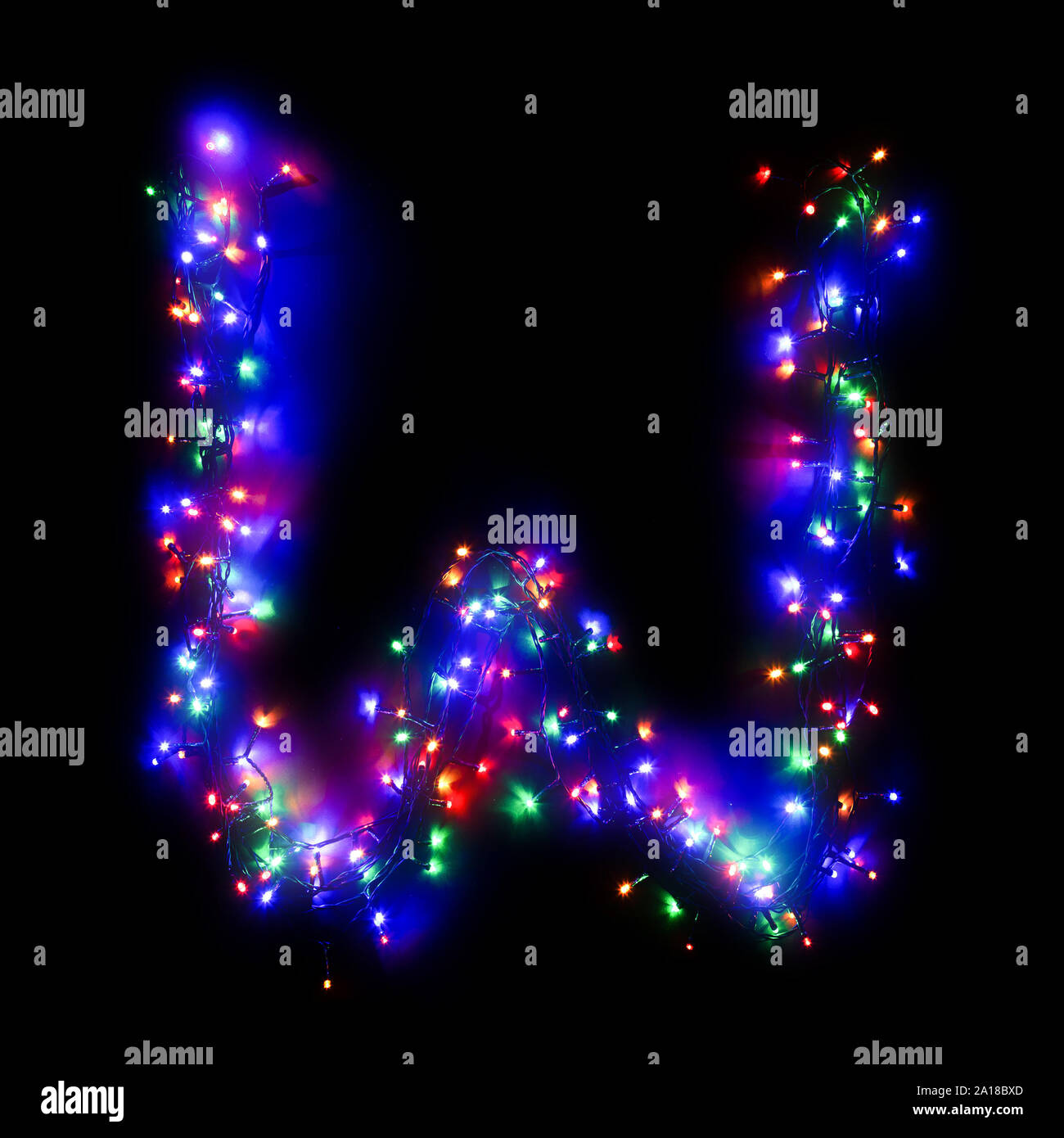 The Letter W Of The English Alphabet From A Multi Colored Electric Garland On A Black Isolated Background New Year S Alphabet Wreath Of Colored Bul Stock Photo Alamy
