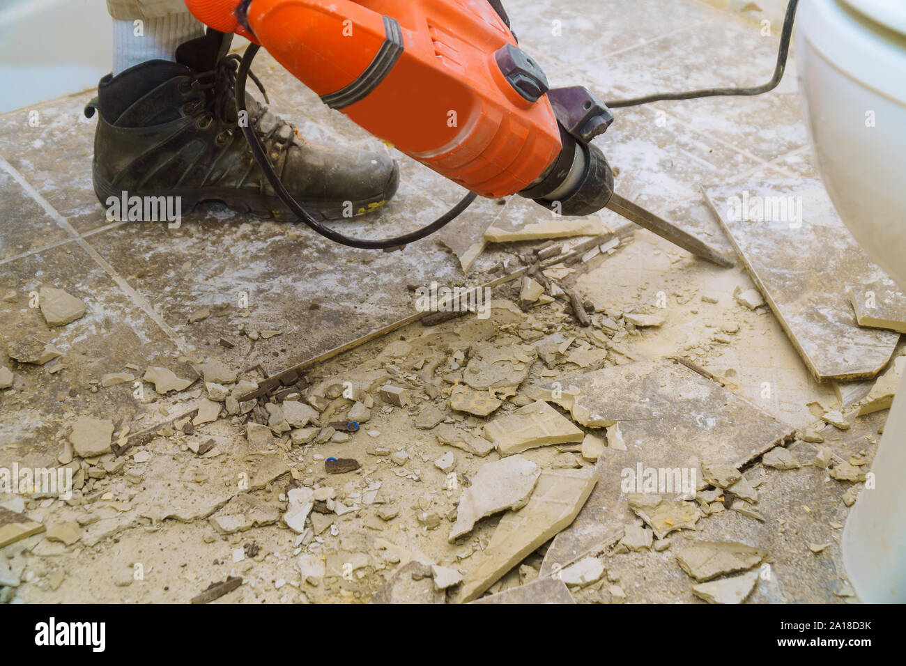 Renovation of old floor demolition old tiles with bath jackhammer Stock