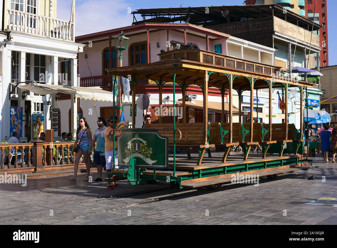 IQUIQUE, CHILE - JANUARY 22, 2015: Unidentified people around an old open tram waggon with wooden seats on Plaza Prat main square in Iquique, Chile Stock Photo