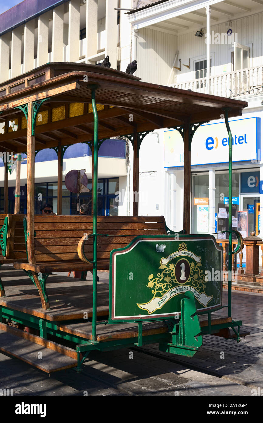 IQUIQUE, CHILE - JANUARY 22, 2015: Old open tram waggon with wooden seats on Plaza Prat main square along Baquedano avenue in Iquique, Chile Stock Photo