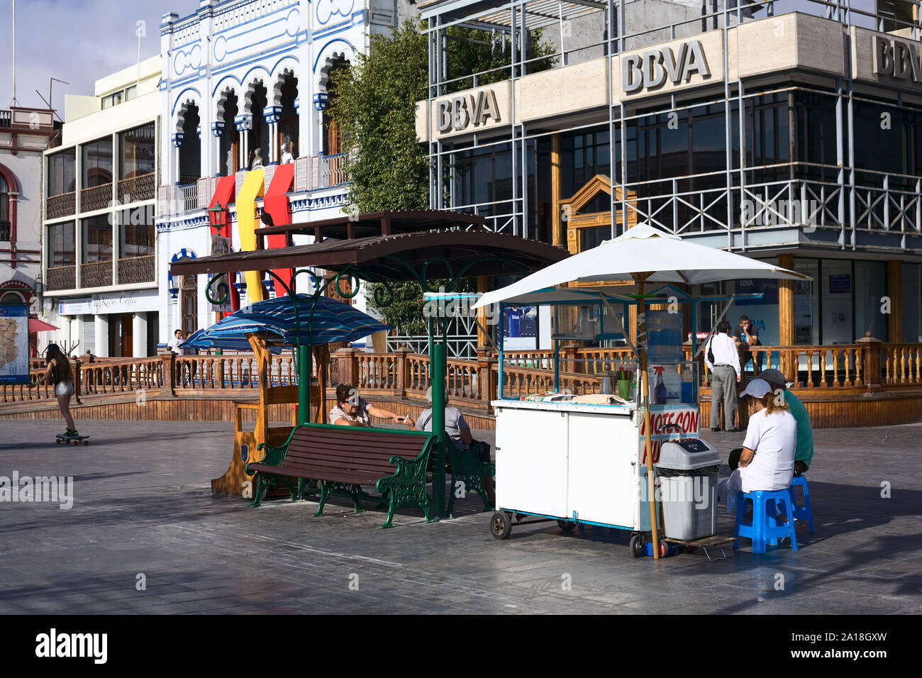 IQUIQUE, CHILE - JANUARY 22, 2015: Unidentified people sitting at Mote con Huesillo (Chilean cold drink) stand on Plaza Prat main square in Iquique Stock Photo