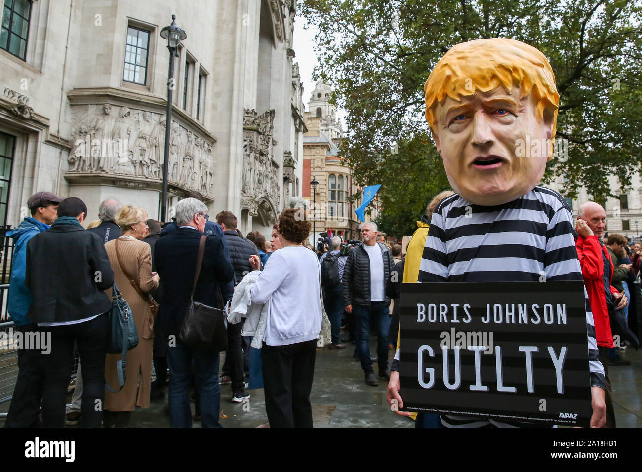 London, UK. 24th Sep, 2019. A protester wearing a prisoner's outfit and British Prime Minister Boris Johnson's face mask outside The Supreme Court on the day the court ruled that the British Prime Minister Boris Johnson's decision to prorogue Parliament is unlawful. Credit: SOPA Images Limited/Alamy Live News Stock Photo