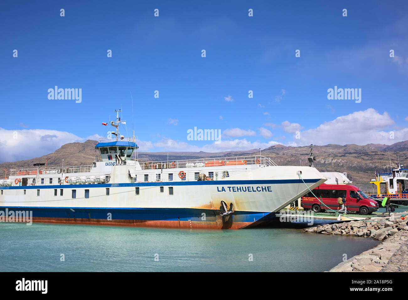 PUERTO IBANEZ, CHILE - FEBRUARY 20, 2016: Unidentified people and minibus leaving recently arrived ferry from Chile Chico in Puerto Ibanez Stock Photo