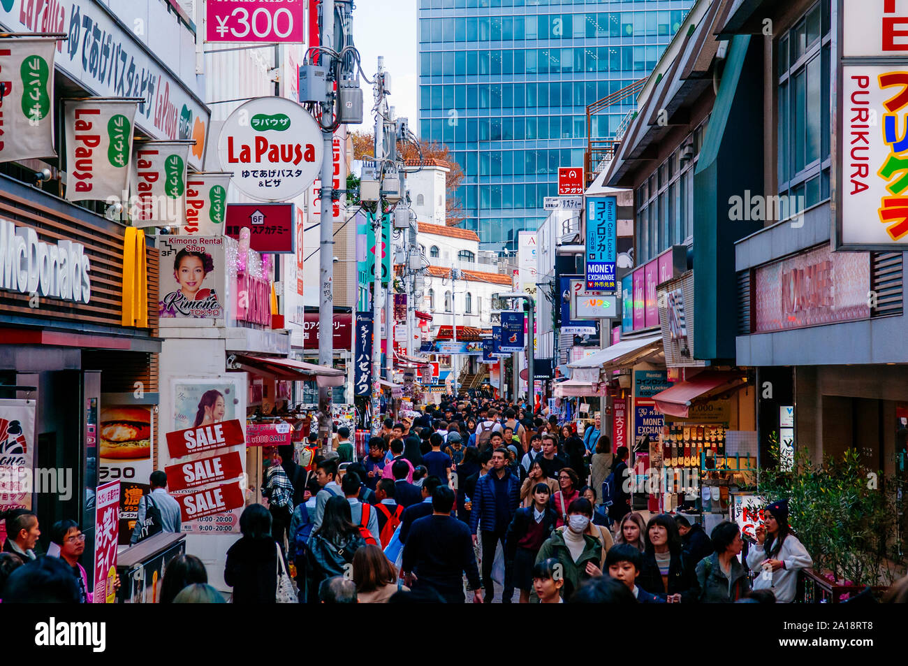 DEC 5, 2019 Tokyo, Japan - Harajuku busy shopping street famous shopping district in Tokyo with many asian tourists with many billboards and shop sign Stock Photo