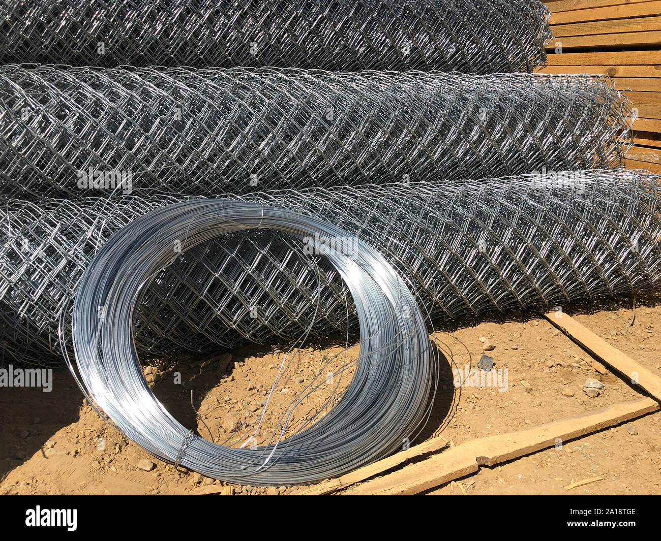 Metal mesh netting rolled into rolls and coils of steel wire. Rolled