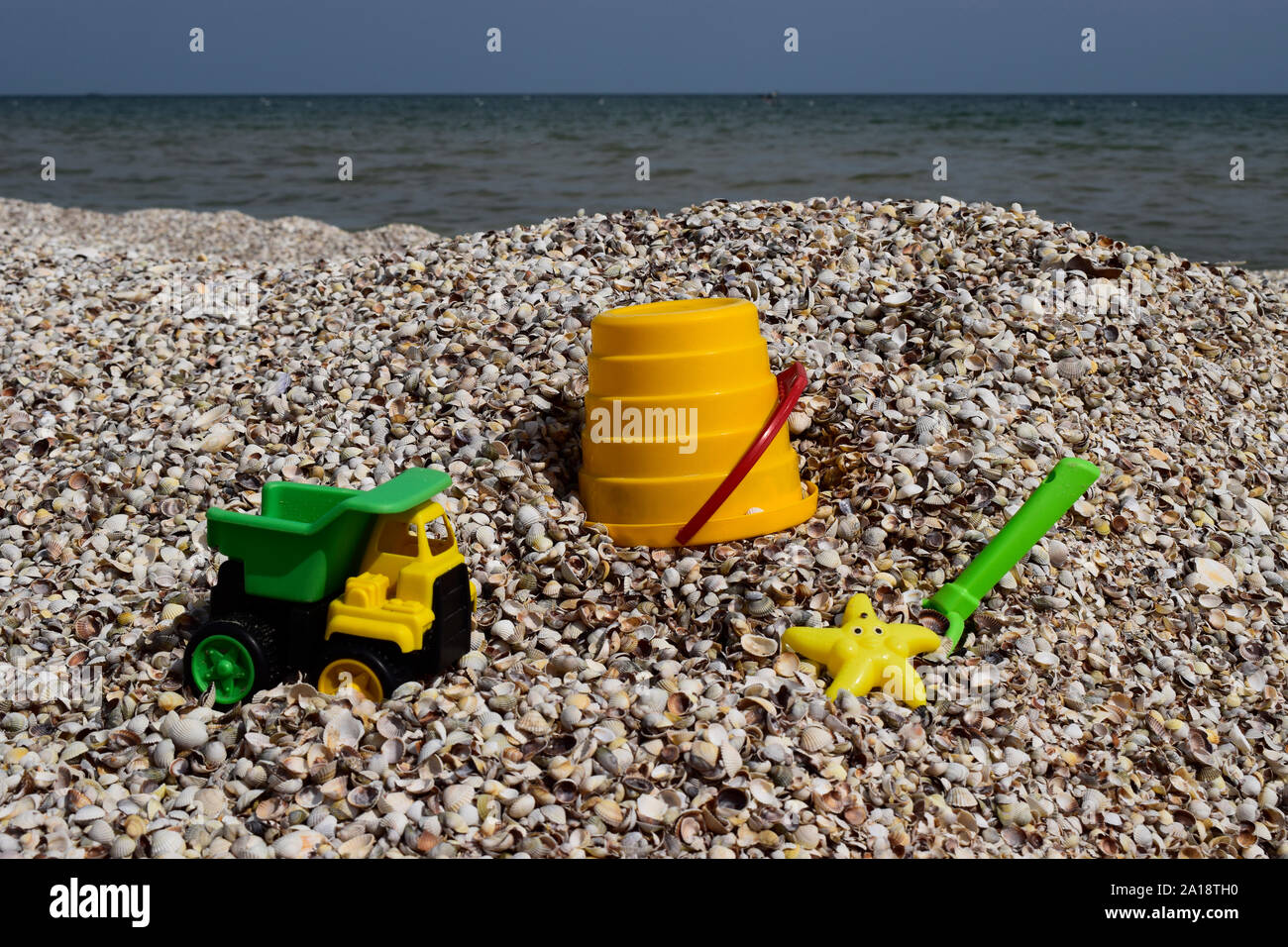 Plastic children's toys for sand on the background of the sea. Kids