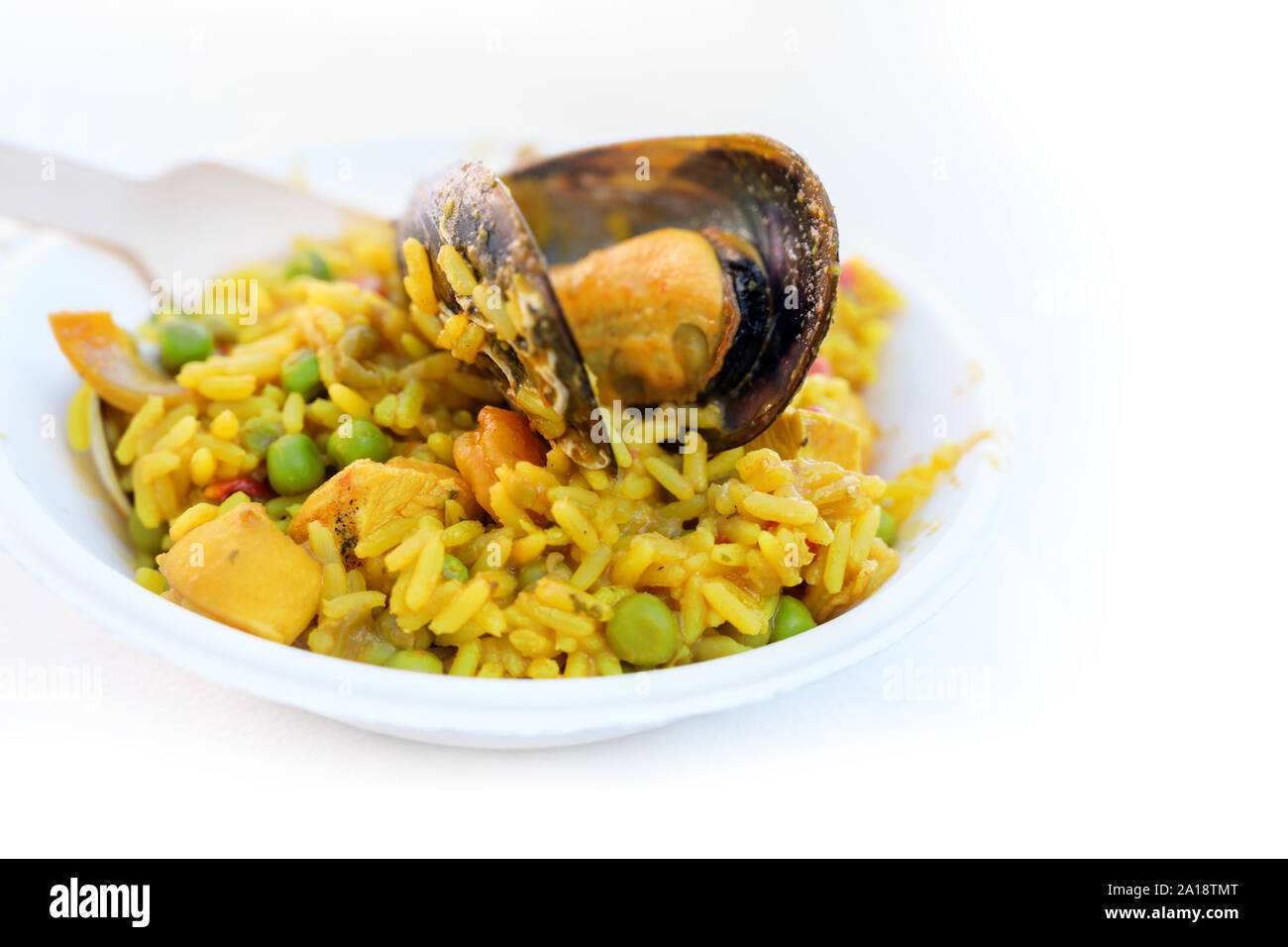 large mussel on a paella portion, spanish street food of rice and