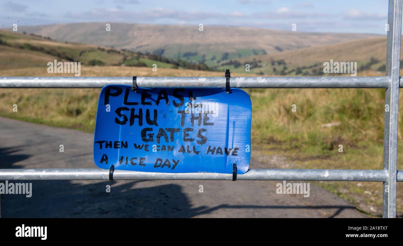 Polite 'Please Shut the Gate' sign on a farmgate. Cumbria, UK. Stock Photo