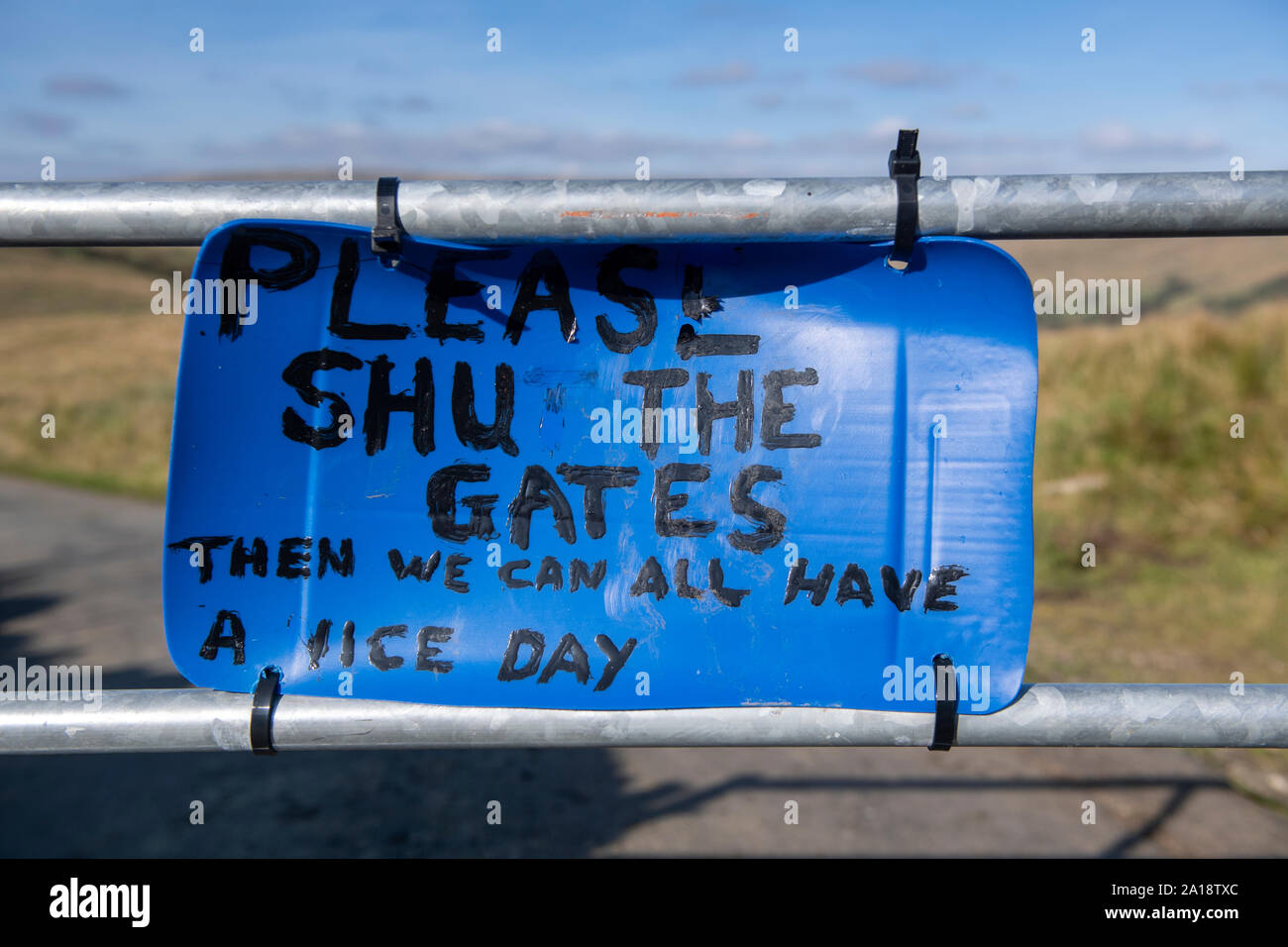Polite 'Please Shut the Gate' sign on a farmgate. Cumbria, UK. Stock Photo