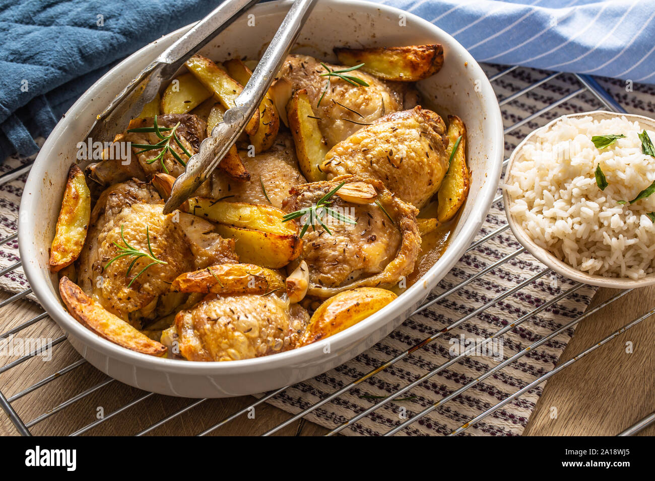 Chicken legs roasted with american potatoes in baking dish Stock Photo