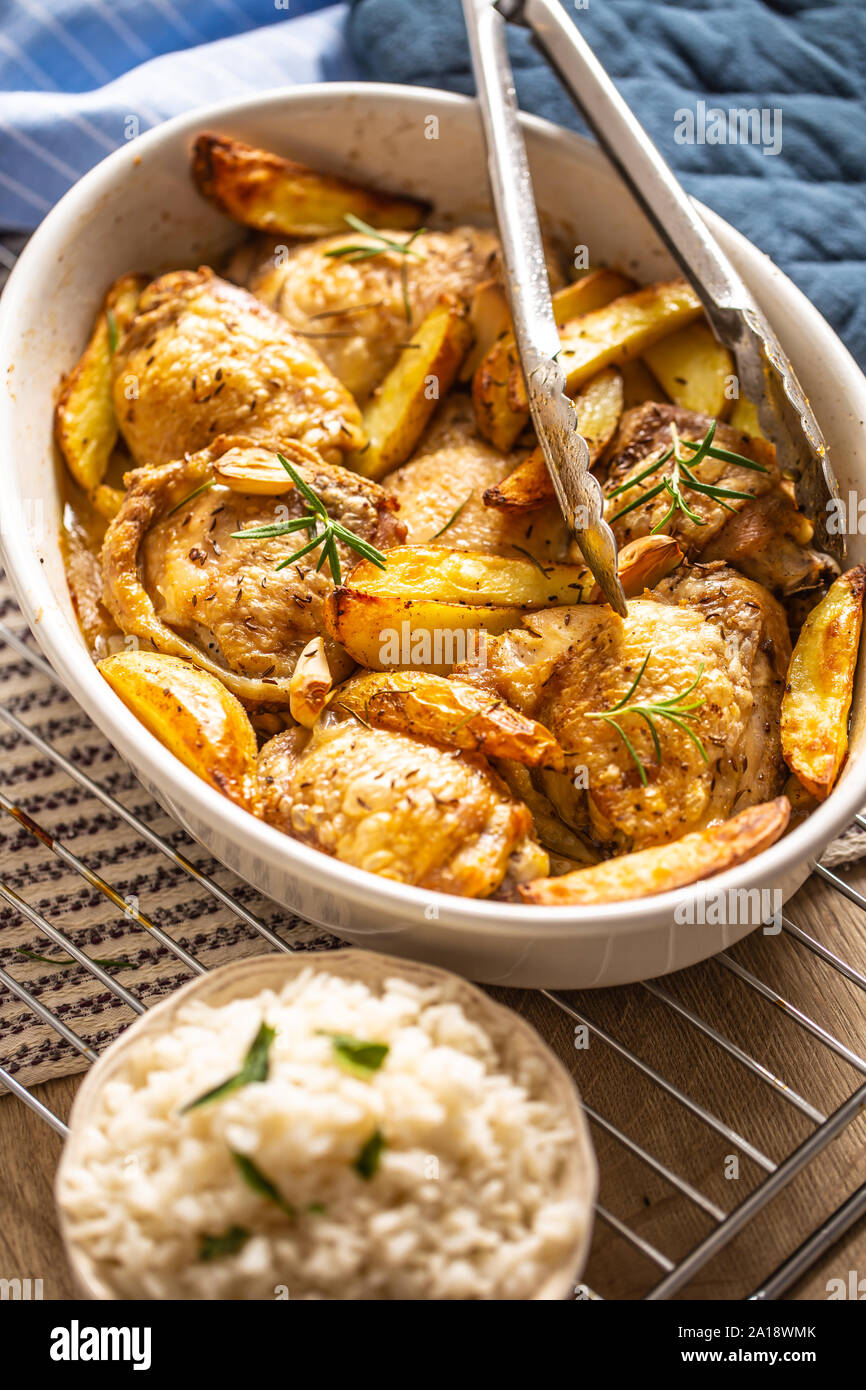 Chicken legs roasted with american potatoes in baking dish Stock Photo ...