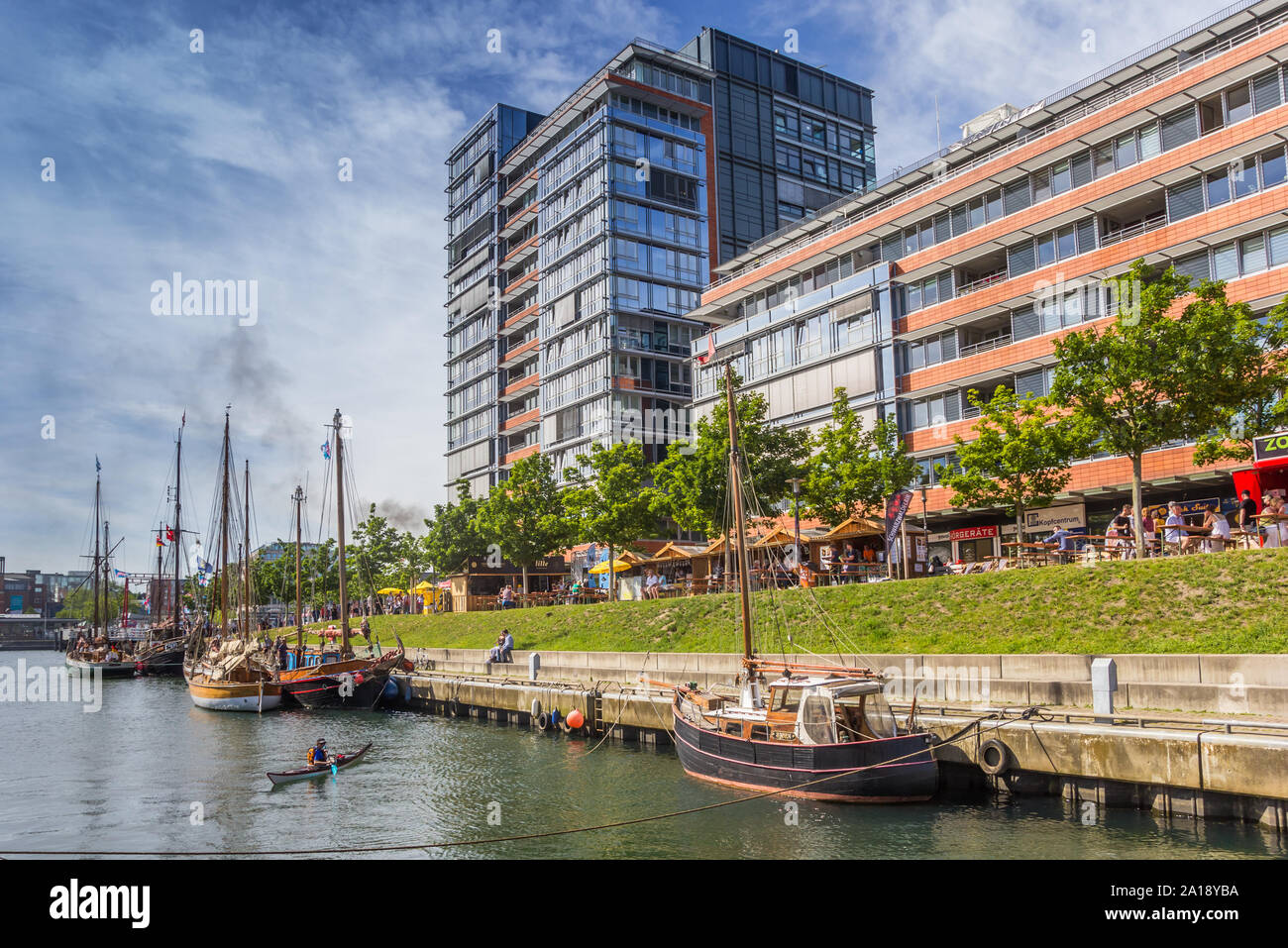 Old ships and modern buildings in the harbor of Kiel, Germany Stock Photo