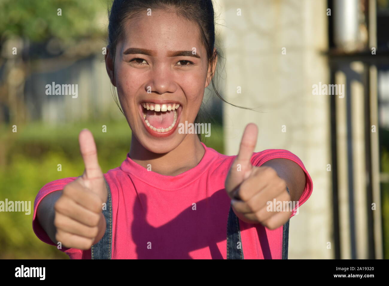 Youthful Minority Female With Thumbs Up Stock Photo - Alamy