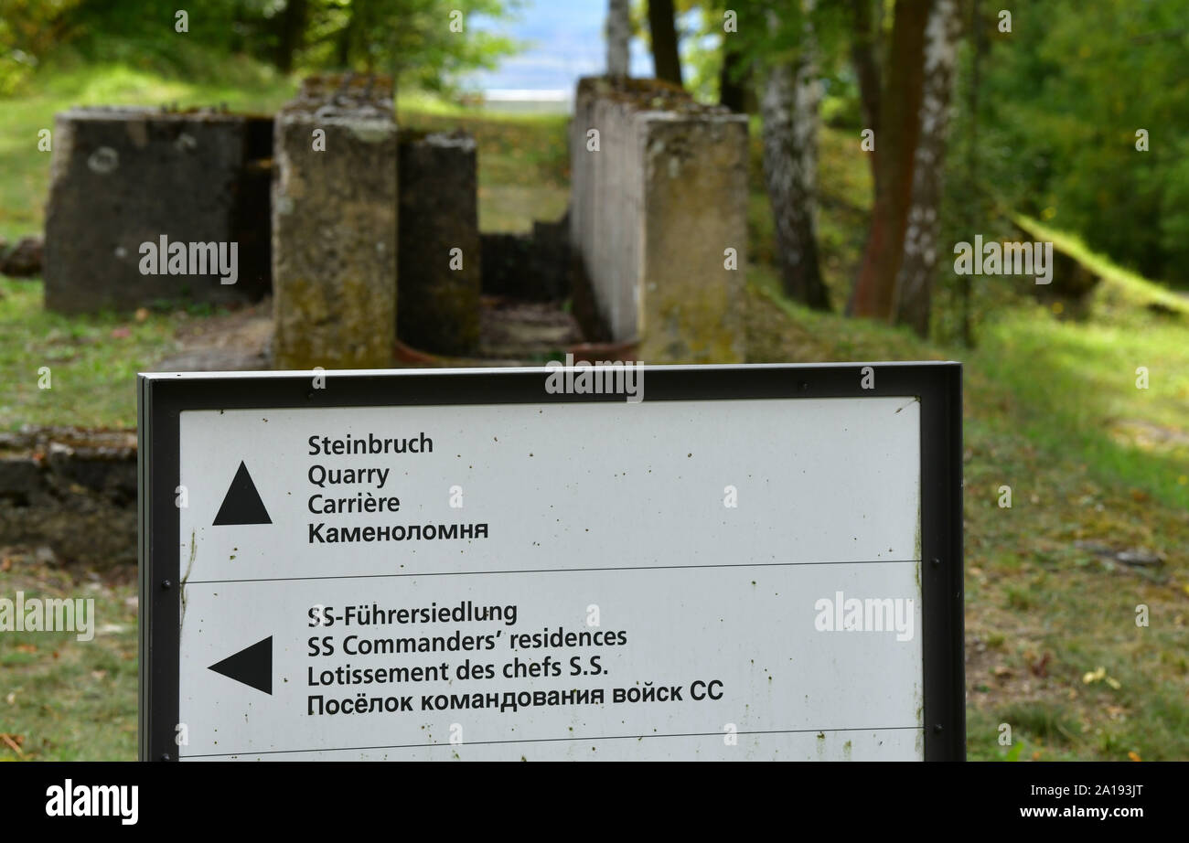 24 September 2019, Thuringia: A sign shows the way to the quarry on the site of the former Buchenwald concentration camp. The Thuringian State Office for Monument Preservation and Archaeology and the Buchenwald and Mittelbau-Dora Memorials Foundation intend to carry out excavations in the quarry in October 2019. In the quarry of the Buchenwald concentration camp, the SS forced prisoners to gain material for the construction of the camp's buildings and roads under the most difficult working conditions. Numerous prisoners died in hard work or were cruelly murdered by SS guards. The SS also execu Stock Photo
