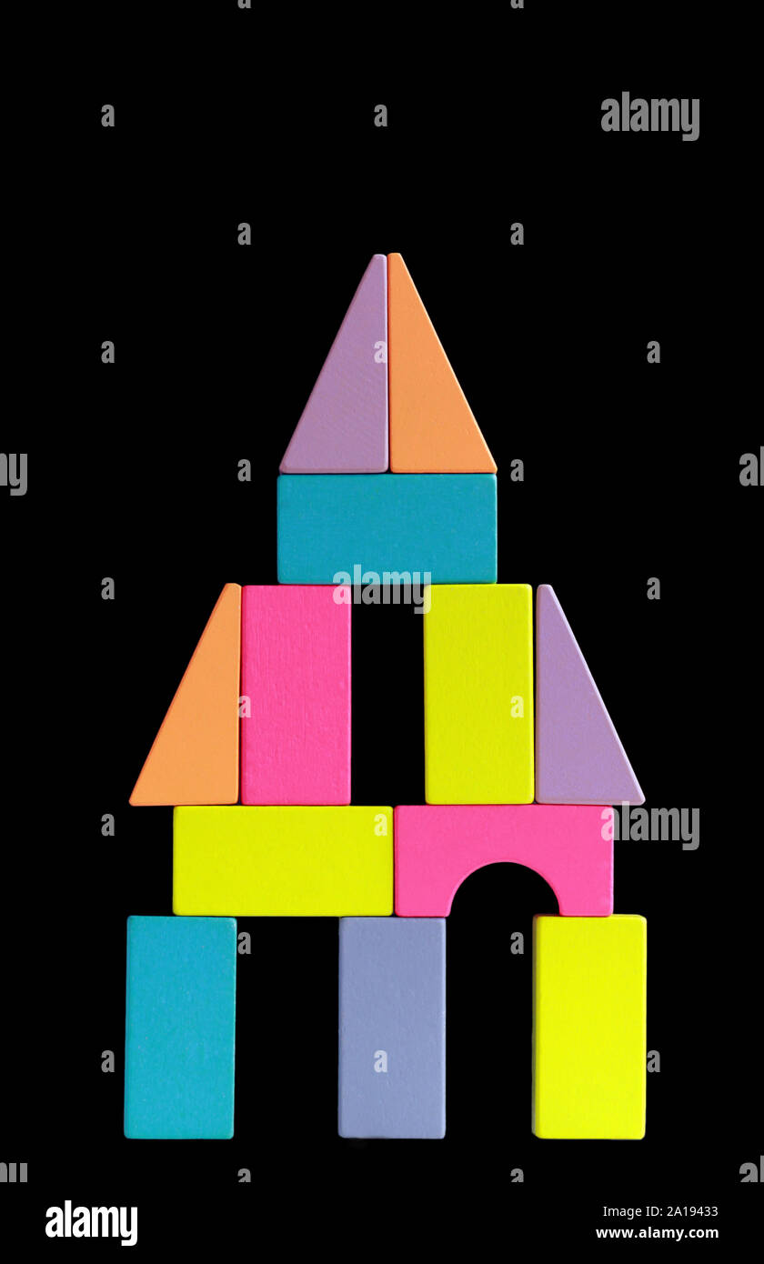 Imaginary construction of colorful wooden blocks over dark background ...