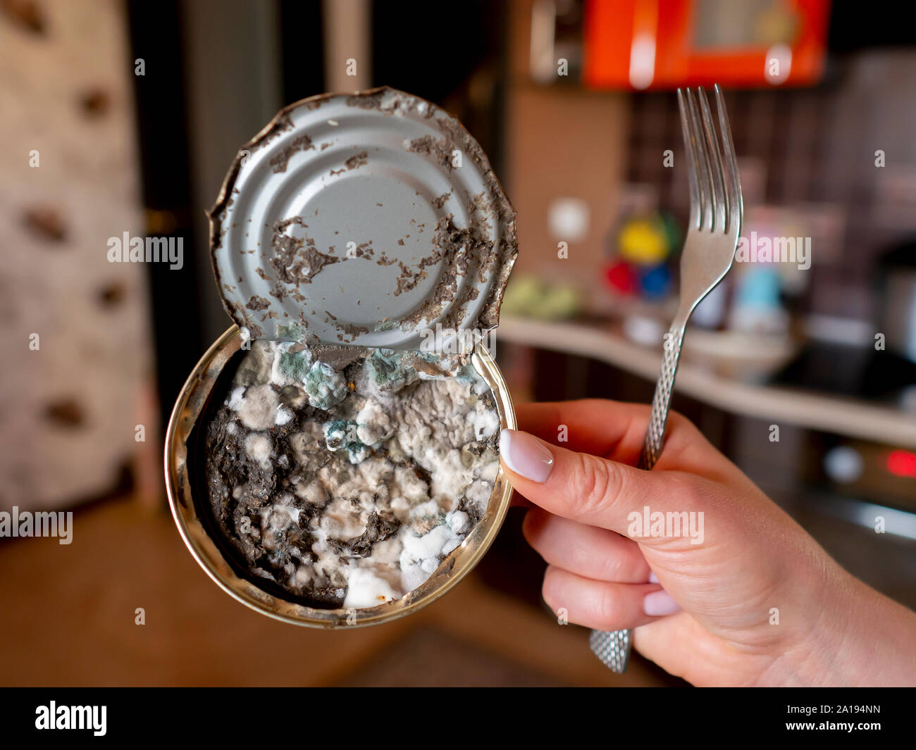 expired canned fish in woman's hand closeup Stock Photo Alamy