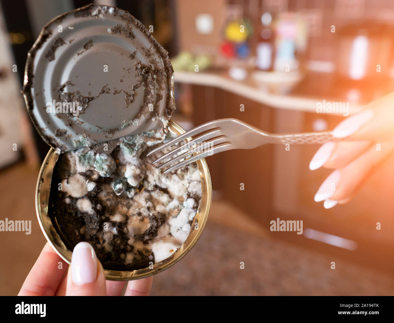 expired canned fish in a woman's hand closeup Stock Photo Alamy