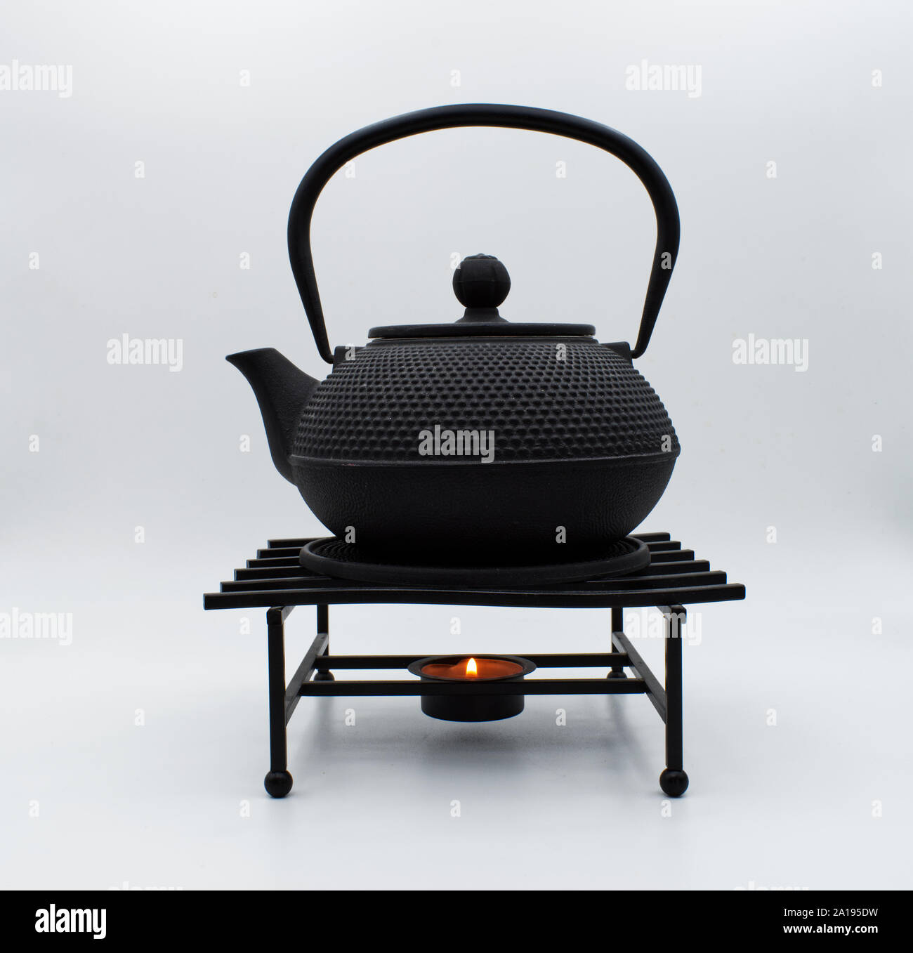 Chinese iron black teapot on display, isolated on white background