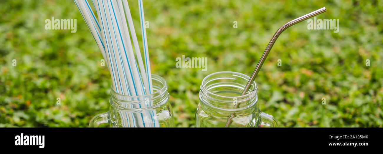 Steel drinking vs disposable straws on grass background. Zero waste
