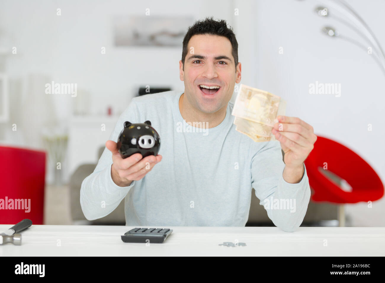 happy man holding a piggy bank Stock Photo - Alamy