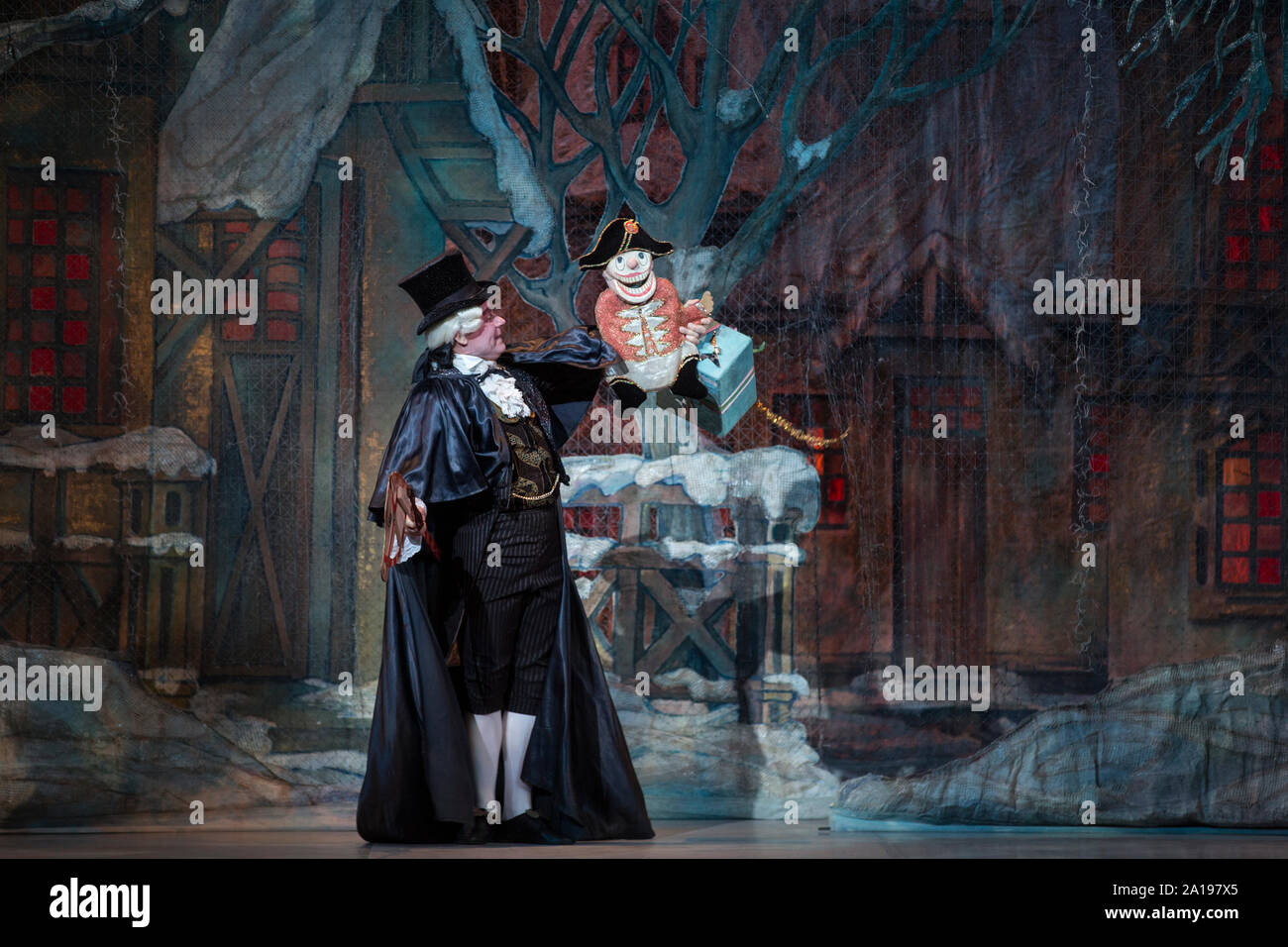 Drosselmeyer carries a Nutcracker doll to children in the ballet the
