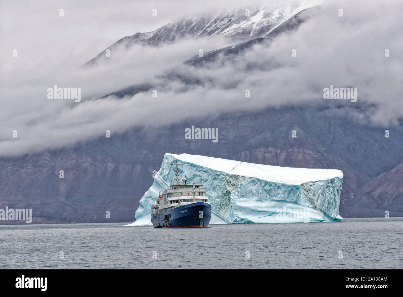 Expeditionsschiff MS Plancius vor Eisberg, Grönland, Dänemark.  MS Plancius in front of an iceberg, Kangertittivaq, Eastern Greenland, Denmark Stock Photo