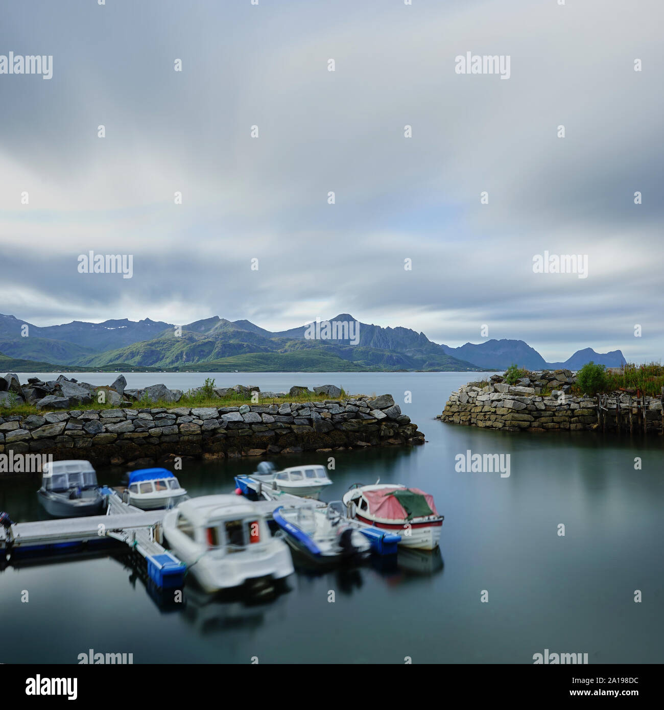 Beutiful landscape with ever changing weather. The small fishing boats swaying in the water. Stock Photo